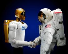 Astronauts shaking hands (one with a prosthetic arm) 