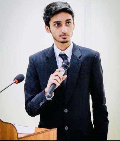 An image of Syed Mohammad Asjad presenting with a microphone