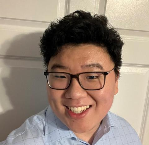 A headshot of Xufei Wang