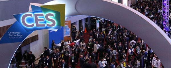 Photo from a CES event with people on the show floor with an arch above them that says CES