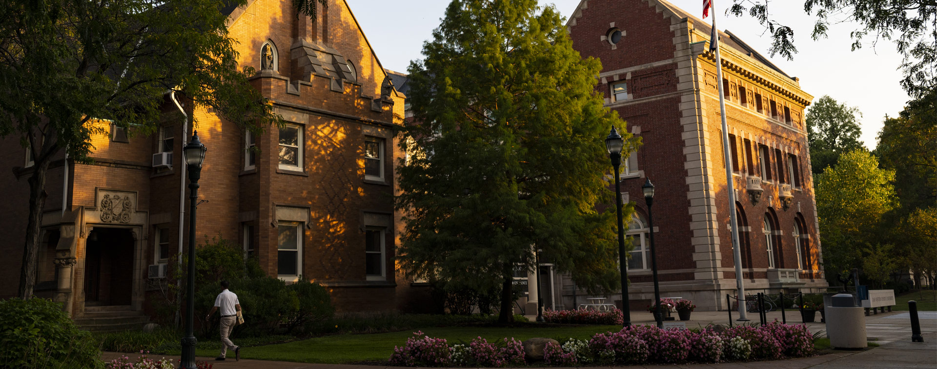 Photo of the sun setting and shining on the Thwing Center on the CWRU campus
