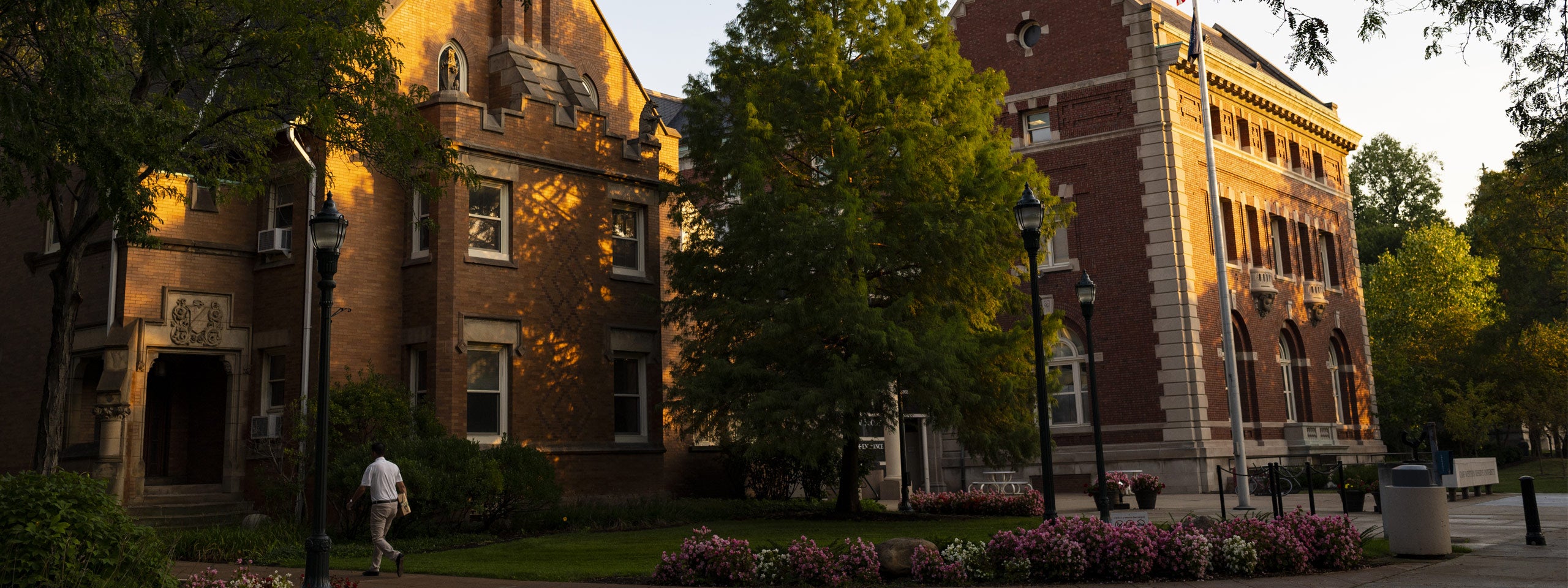 Photo of the sun setting and shining on the Thwing Center on the CWRU campus