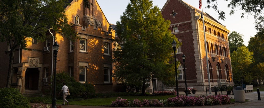Photo of the sun setting and shining on the Thwing Center on the CWRU campus