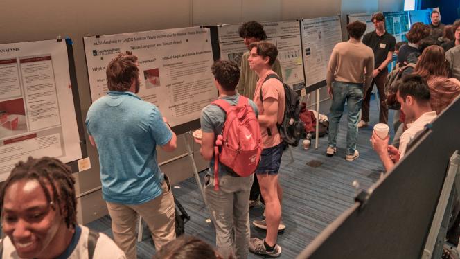 students with posters at think tank