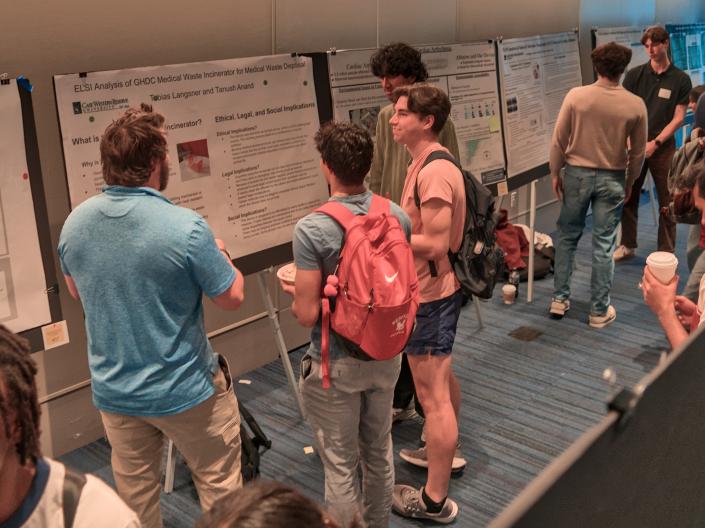 students with posters at think tank