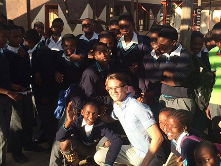 Students posing with local family while studying abroad