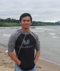 A picture of David Ariando standing on a beach