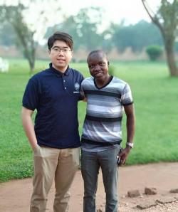 Bill Ding with a student from Makerere University in Uganda