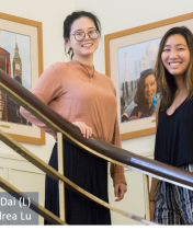 A picture of Andrea Lu and Weiwei Dai standing on the stairs inside Tomlinson Hall 
