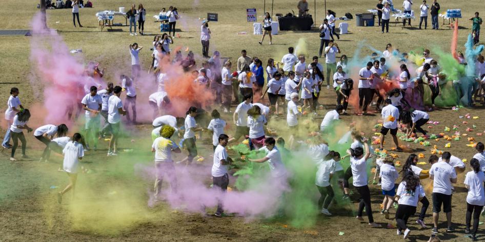 Students throw color during the 2019 Holi festival