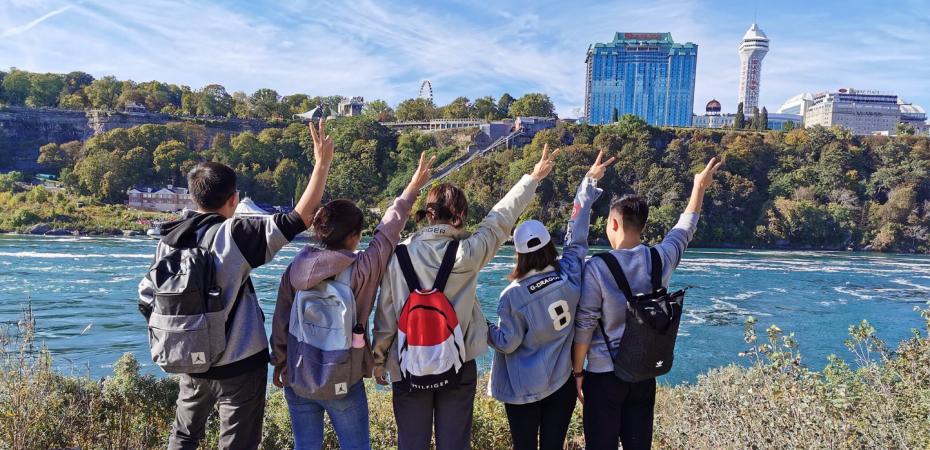 A group of CWRU international students stand looking at Niagara Falls