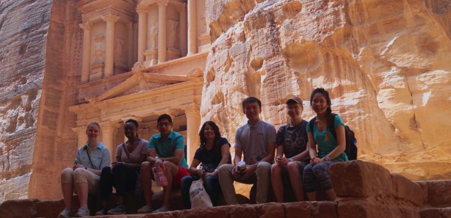 A group of students sit with a faculty member during a short-term study abroad program in Jordan