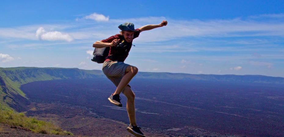 A student jumps for joy during his study abroad experience