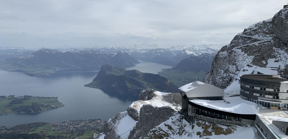 A snowy mountainside overlooking an expansive landscape