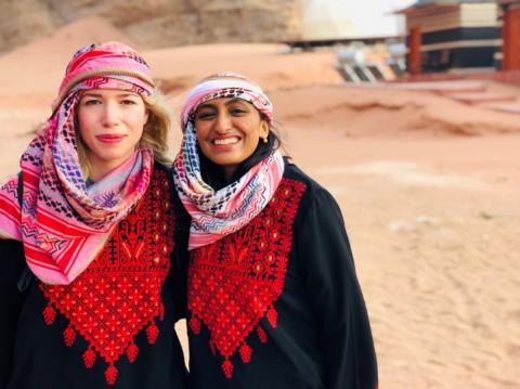 A photo of Nandita and her friend standing in the Wadi Rum desert of Jordan 