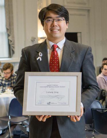 A picture of Yuliang "Bill" Ding with his award