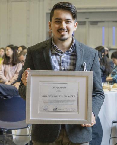 A picture of J. Sebastian Garcia Medina with his award