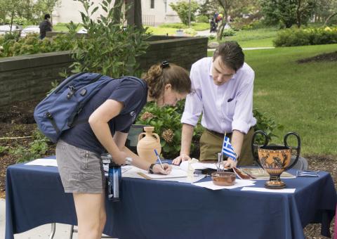 A student signs up to learn more about a Classics program to Greece during the Study Abroad Fair