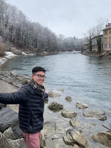 Jeremy Nguyen stands next to a river during his study abroad