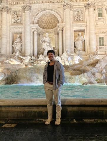 Youssef stands in front of a fountain on his study abroad