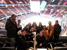 A picture of students at a Cleveland Cavalier's game with their backs to the court