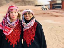 A picture of Nandita Kannapadi standing in the desert in Jordan with her friend during their study abroad