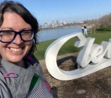 Cami stands in front of a white sign that reads "Cleveland" at Edgewater Park