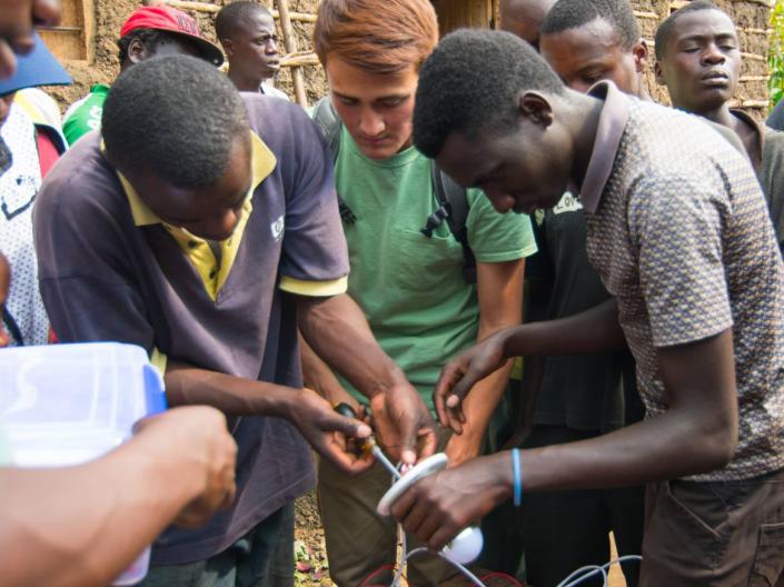 CWRU student engaged in creating thermal energy device with locals
