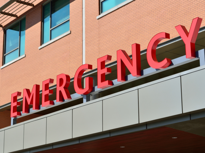 A building with a sign that says "Emergency" in red letters