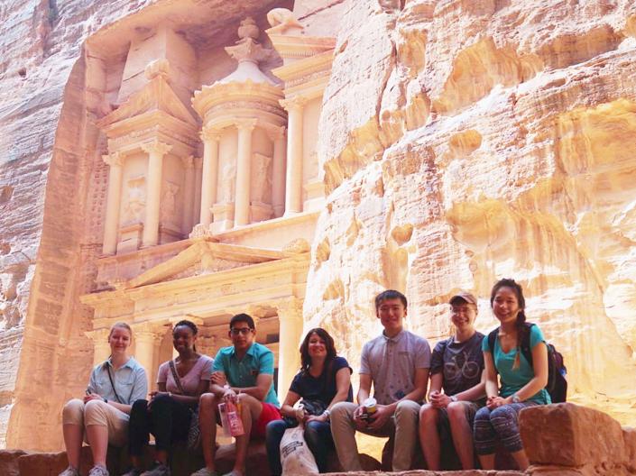 Dr. Cheryl Toman sits with a group of students on a study abroad program in Jordan