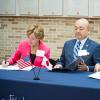 CWRU and Tohoku University officials sign agreements while sitting at a table