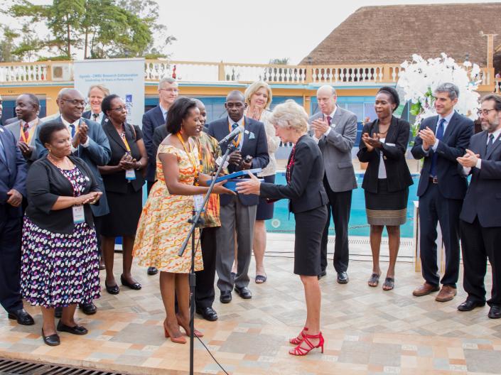 President Snyder accepts a gift from a group of alumni in Uganda