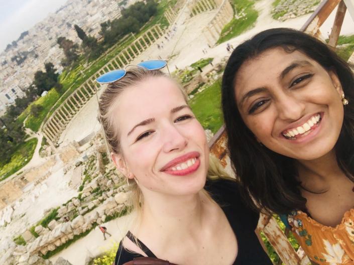 Two female CWRU students stand together smiling outside during a study abroad trip
