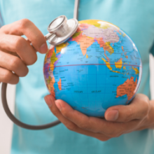 Image of health professional holding a globe