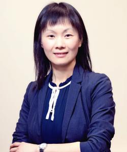 Smiling photo of Dr. Ye in blue jacket and blouse, arms folded at waist