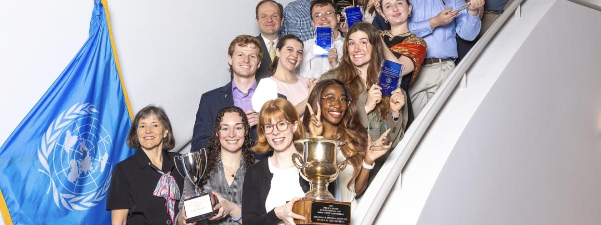 Photo of students holding plaques and trophies.