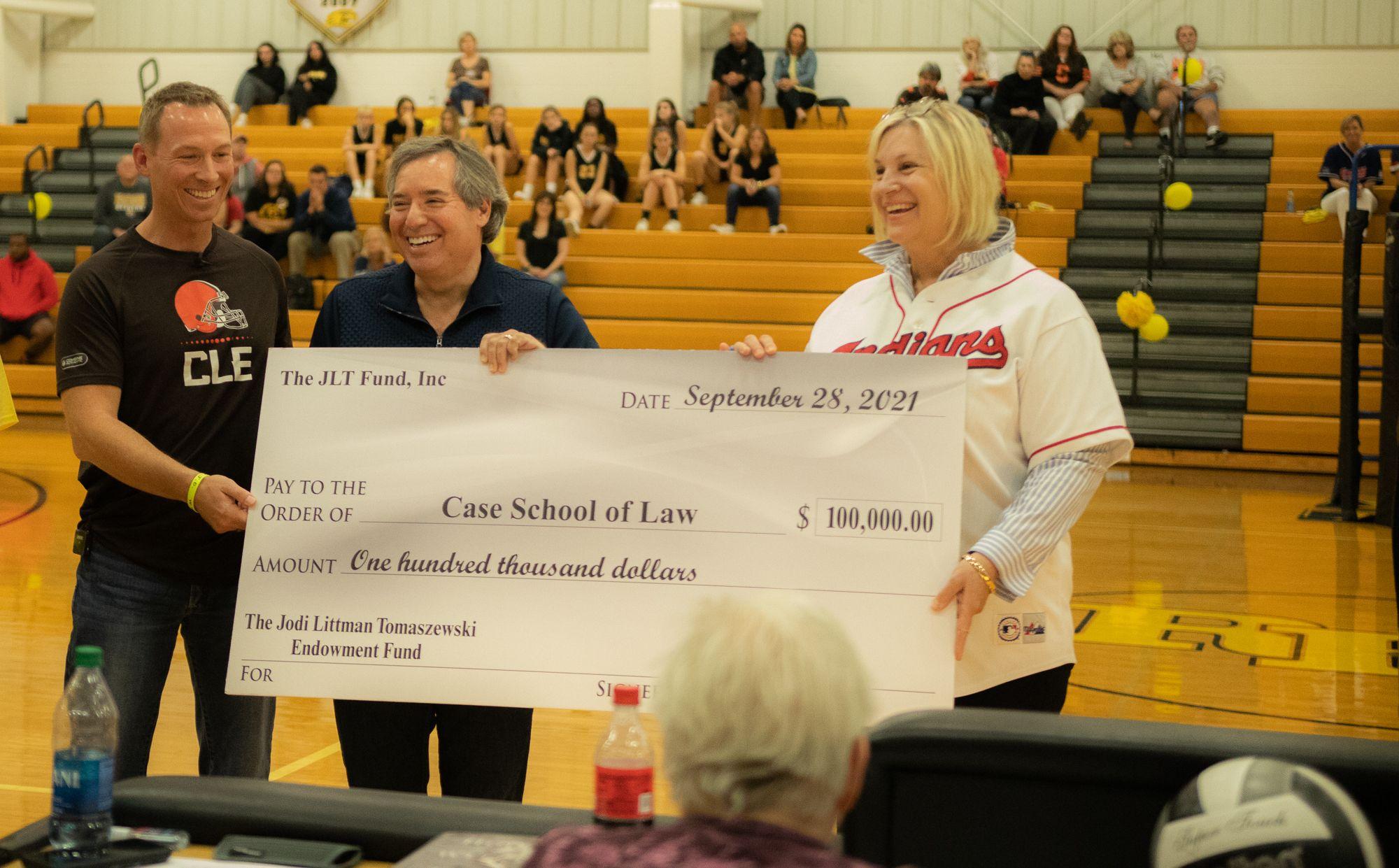 Michael Scharf receives scholarship check