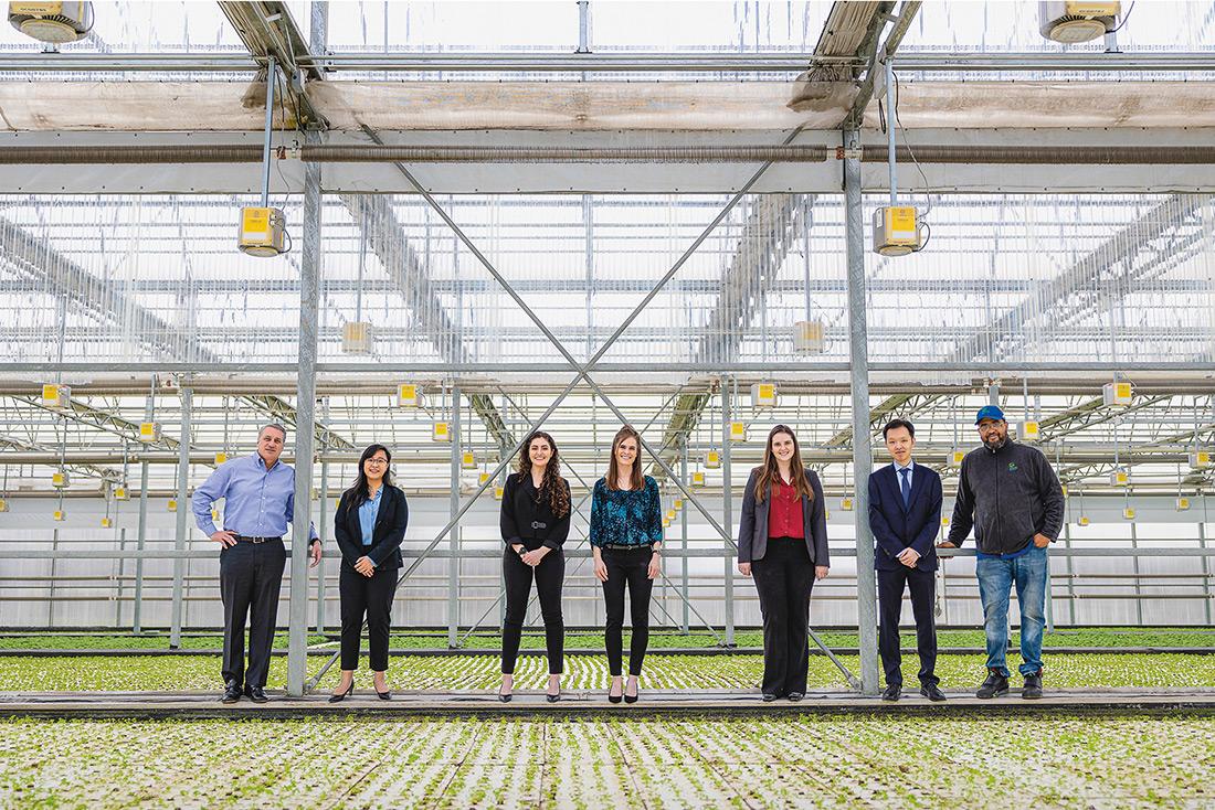 Students and professor lined up for photo inside Greenhouse Growers