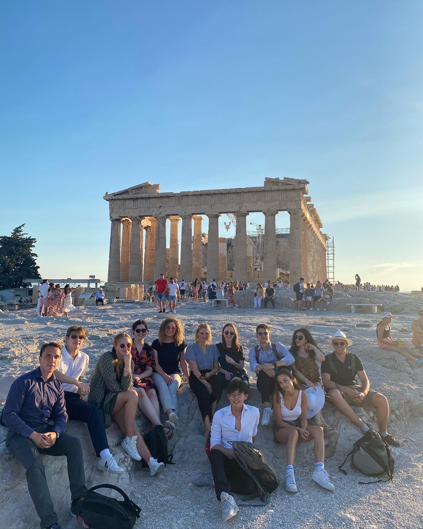 Students sitting in front of the Parthenon