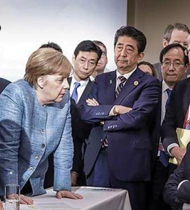 A group of speakers surrounding president Trump