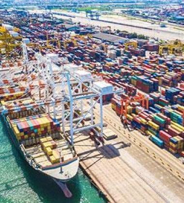 Trade ships loaded with cargo at a dock