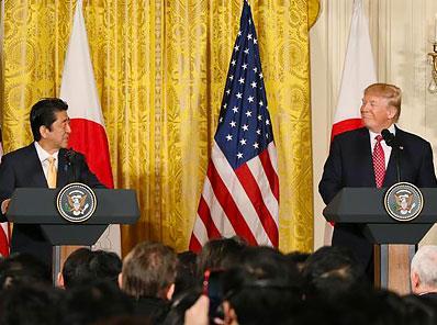President Donald Trump speaking at a podium on trade negotiations