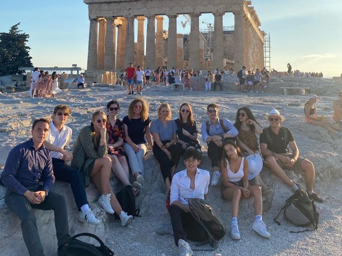 Students sitting in front of the Parthenon