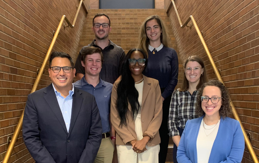 First amendment clinic staff and interns gather on the law school stairs to pose for a photo