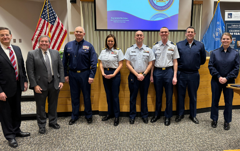 Richard Batson (third from left) with local members of the Coast Guard, Co-Dean Michael Scharf and Stephen J. Petras. 