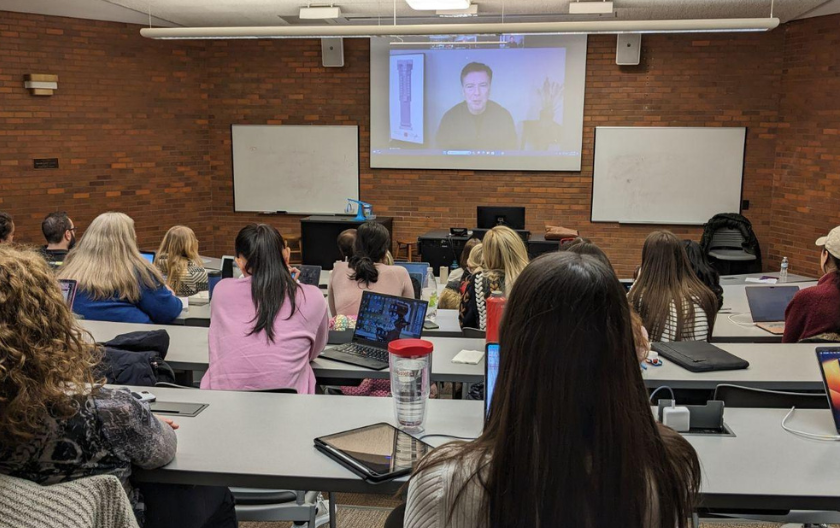 Comey being displayed on Zoom projector with students in the foreground
