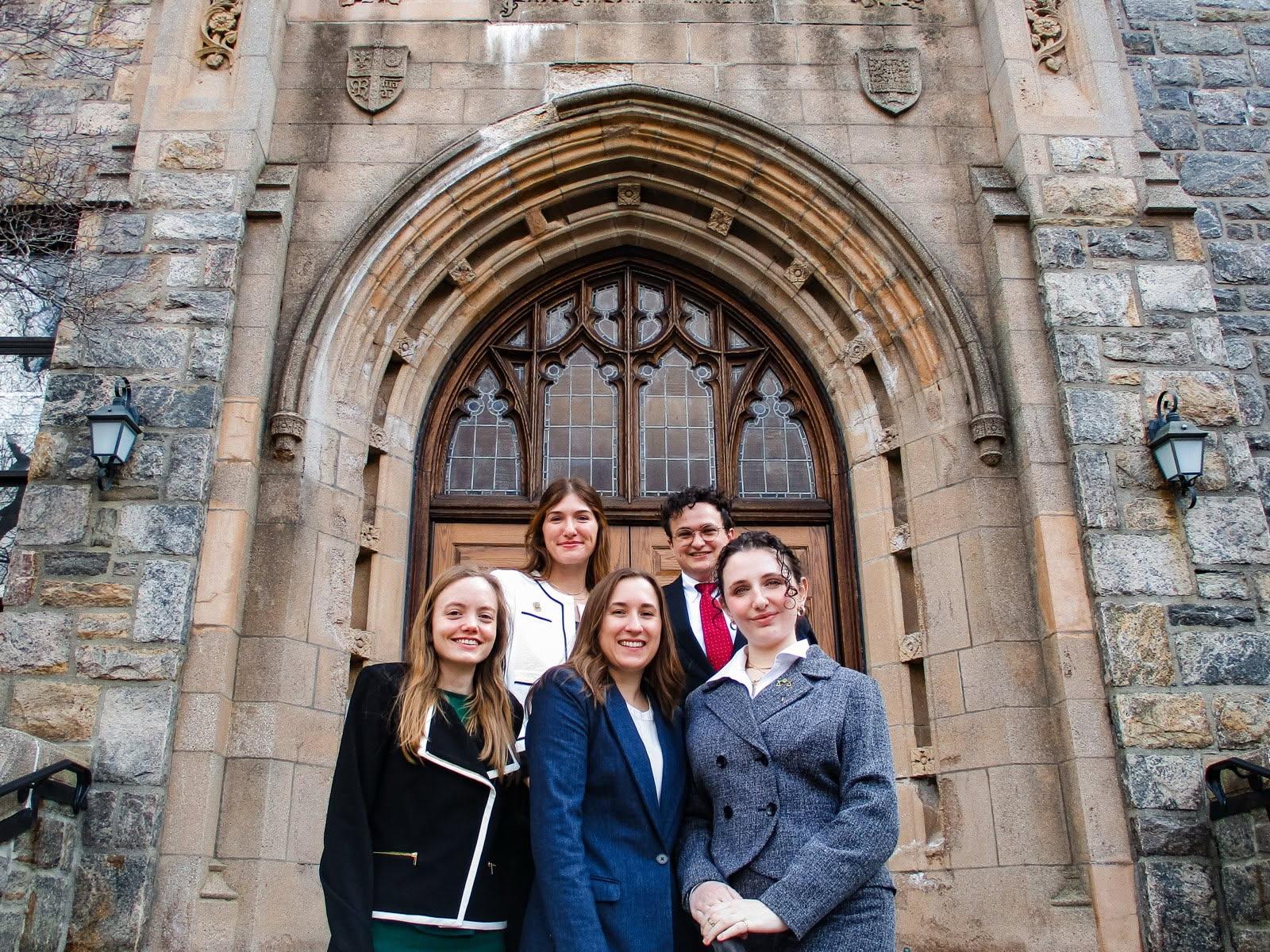 2025 ICC moot court team standing in front of old stone building