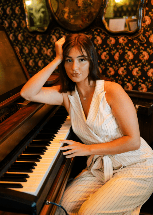 Sophia sitting at a piano