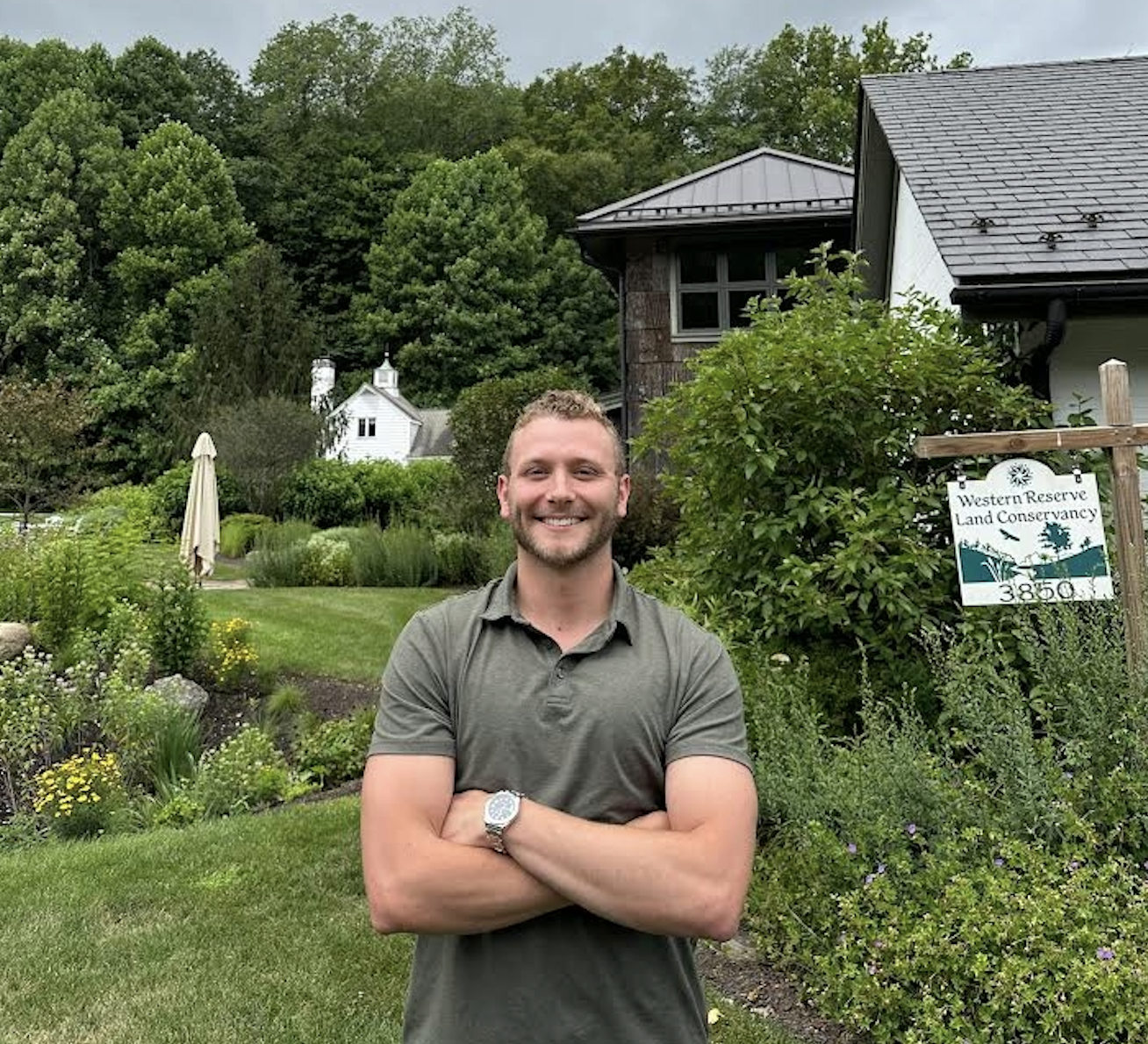 Logan Byler standing in front of a sign for the Western Land Conservancy