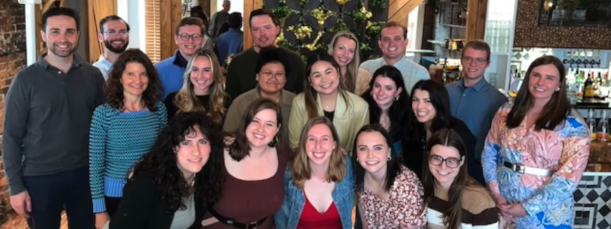 A group of students gathered, all facing the camera and smiling
